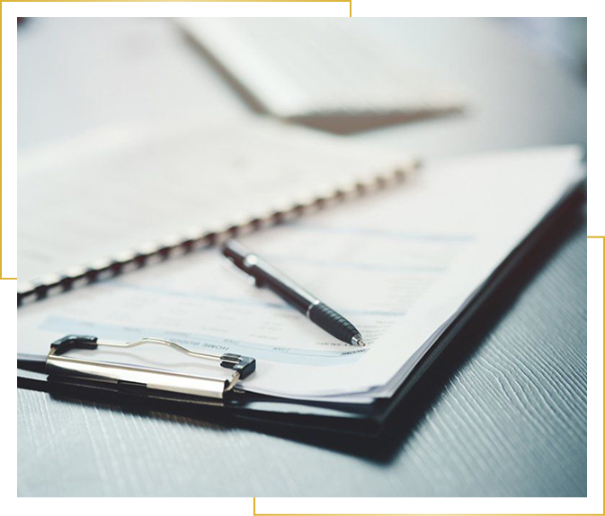 Clipboard with pen on documents
