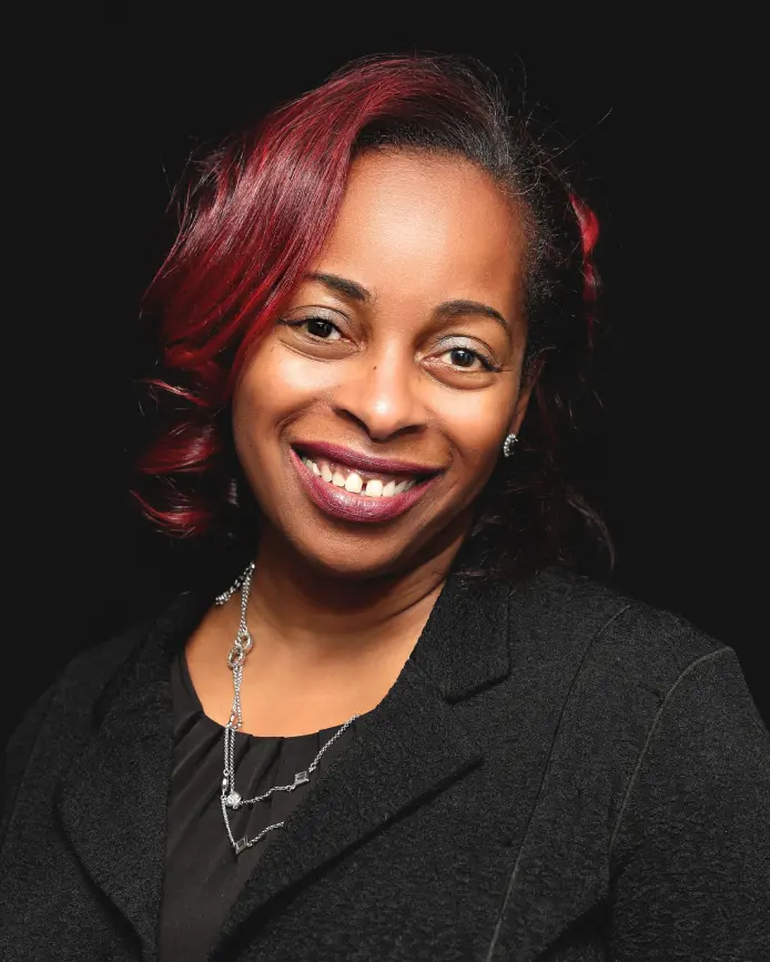 Woman in black blazer, smiling