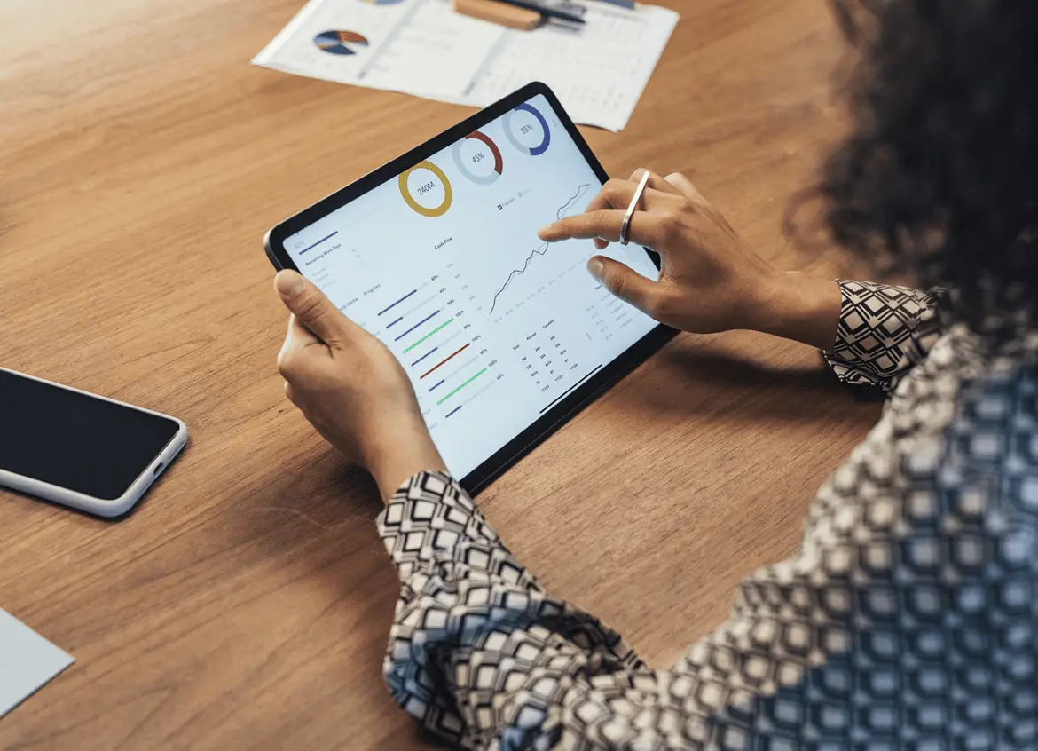 Person analyzing data on a tablet with stylus in hand.