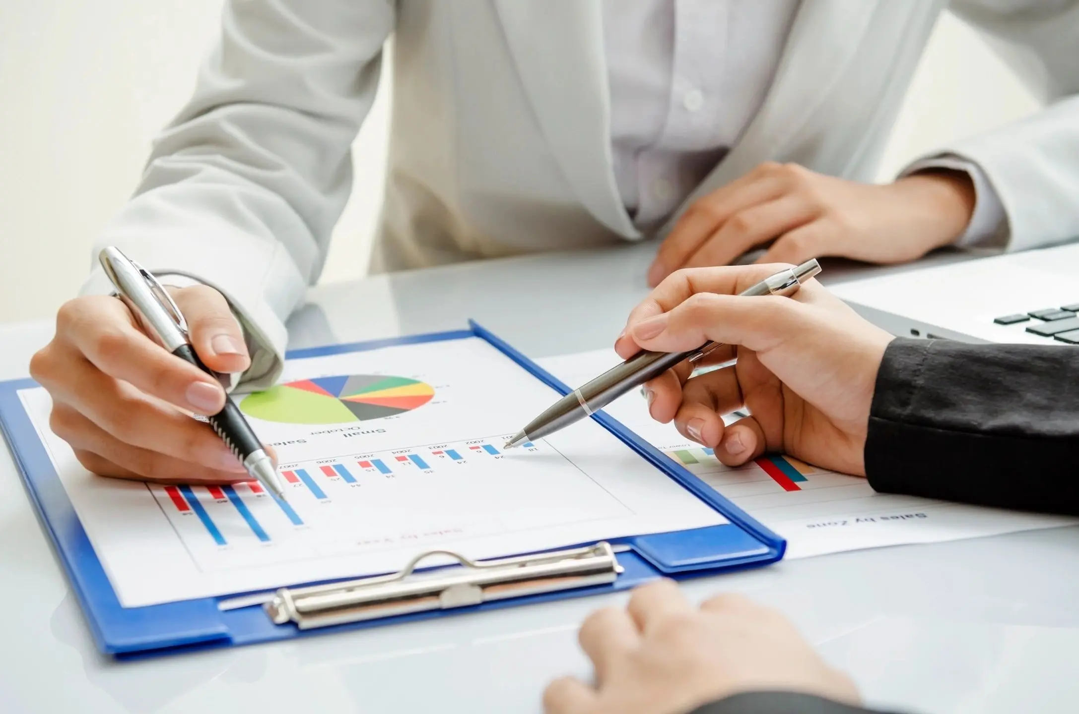 Business professionals analyzing charts and graphs during a meeting.